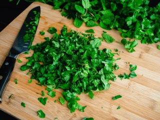 Posiekana natka pietruszki na drewnianej desce