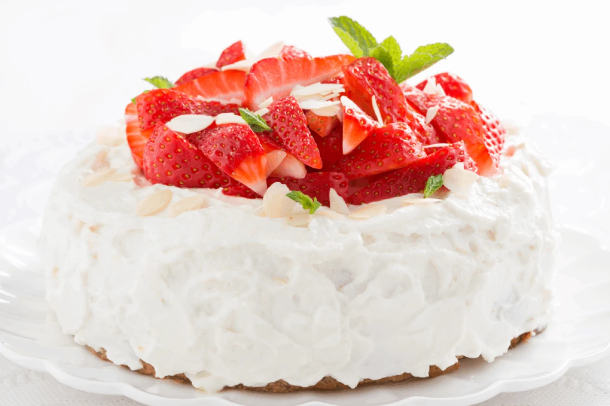 Tort z bitą śmietaną udekorowany truskawkami