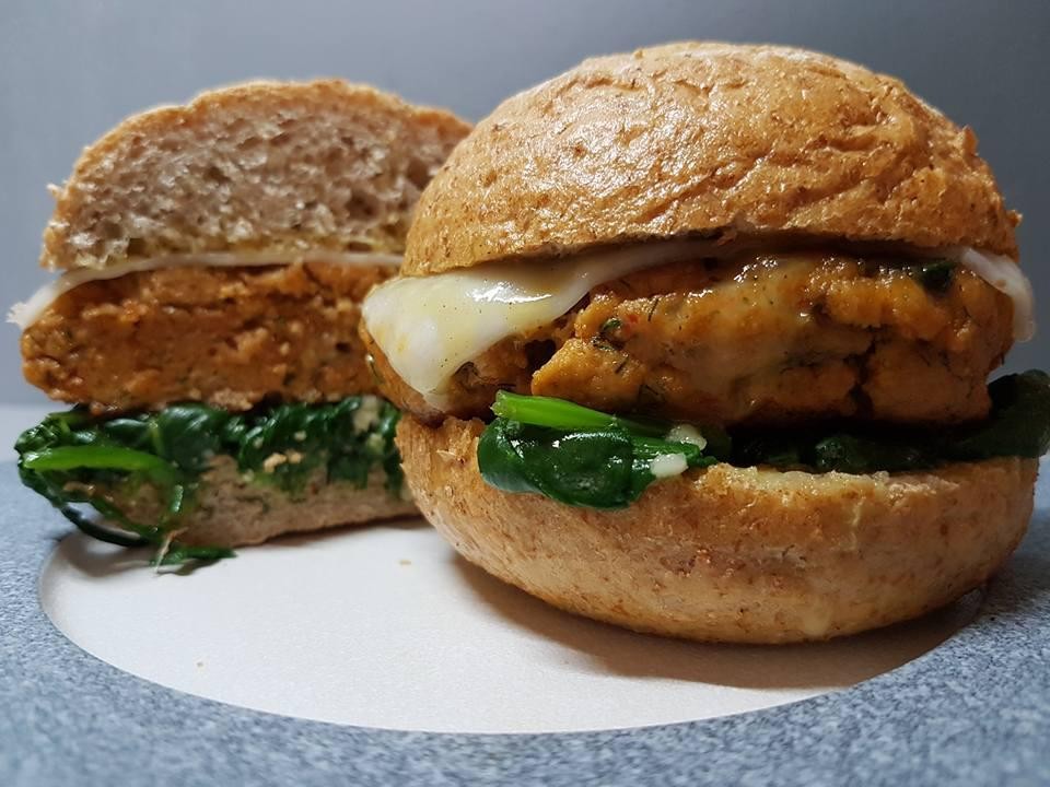 Łososiowy burger na szpinaku baby z kozim serem.